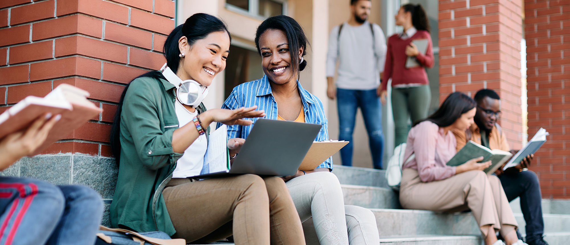 Students laughing and working together on campus